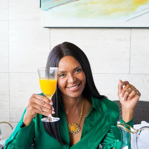 At a table, with a glass of orange juice