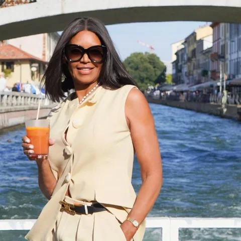 On a boat trip, holding a drink