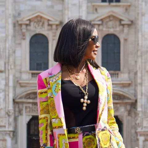 In a colourful jacket in front of a cathedral